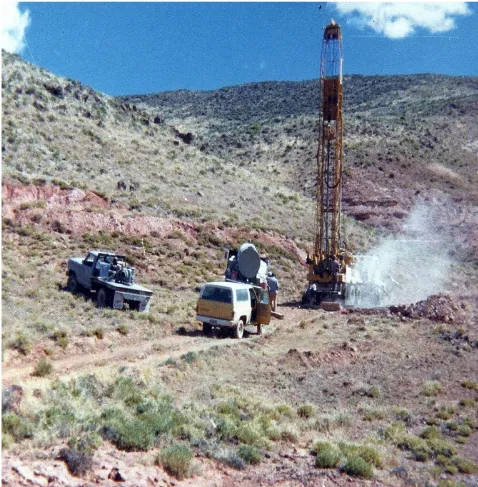 Earth Power drill rig and trucks at a hillside geothermal site