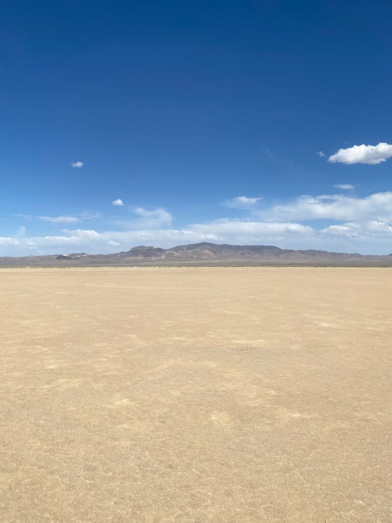 Dry playa and distant mountains under a blue sky in Nevada